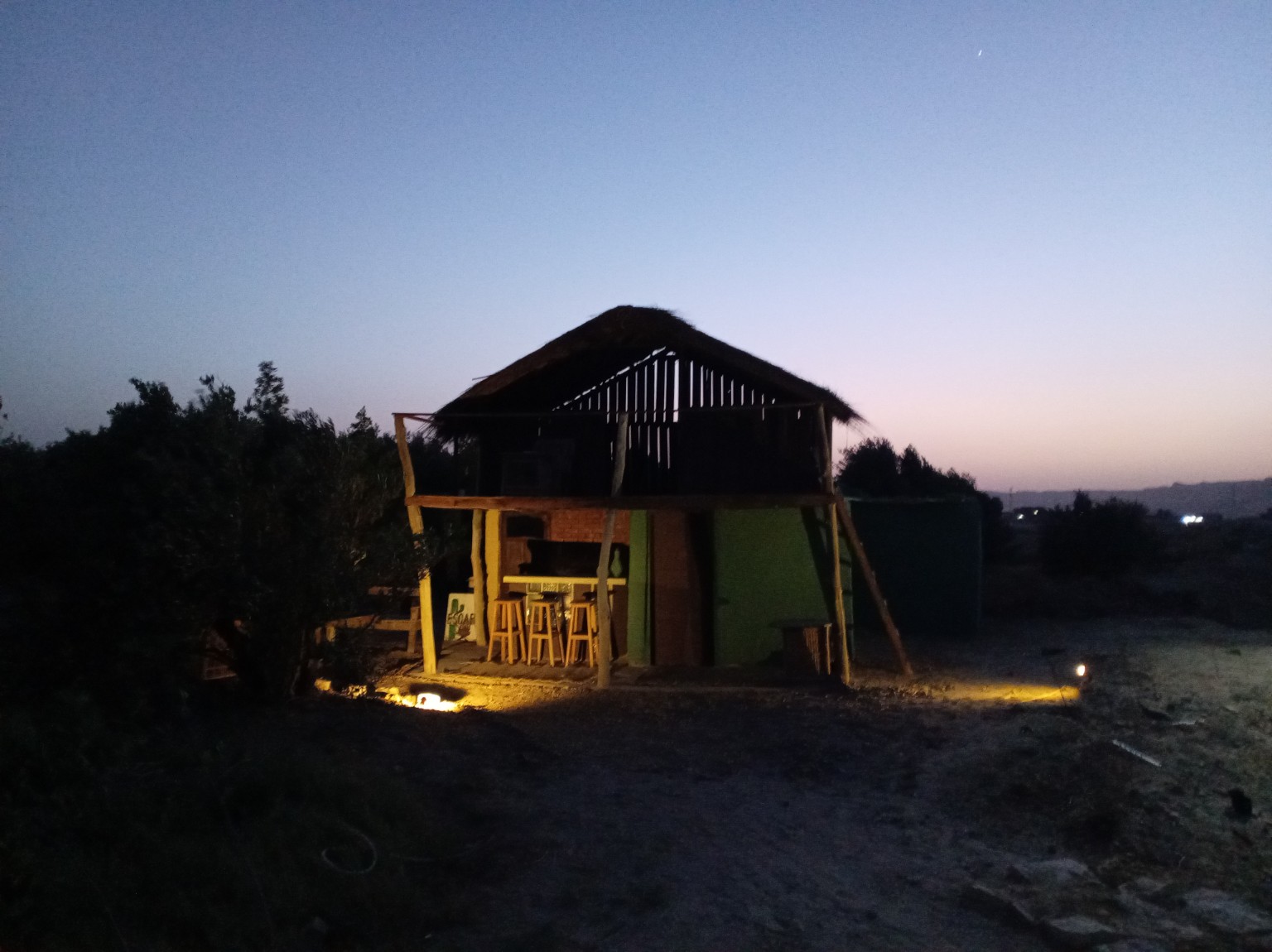 Cabin and outdoor seating at dusk