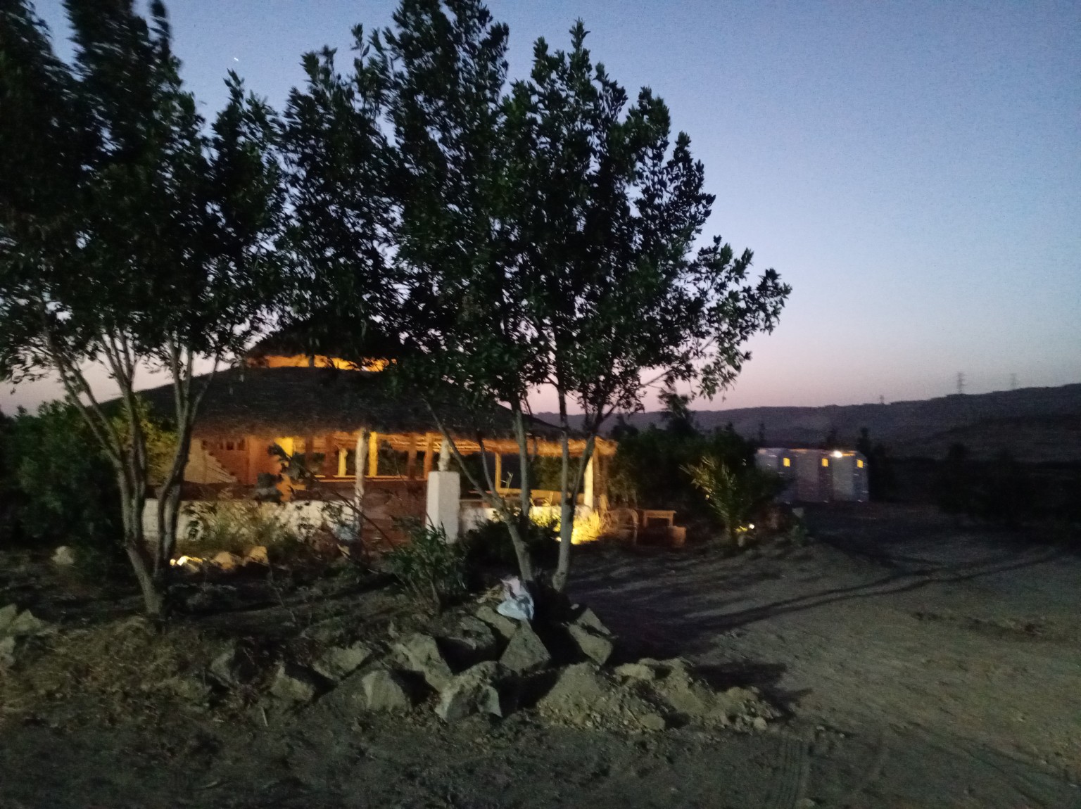 Camp gathering space illuminated at night